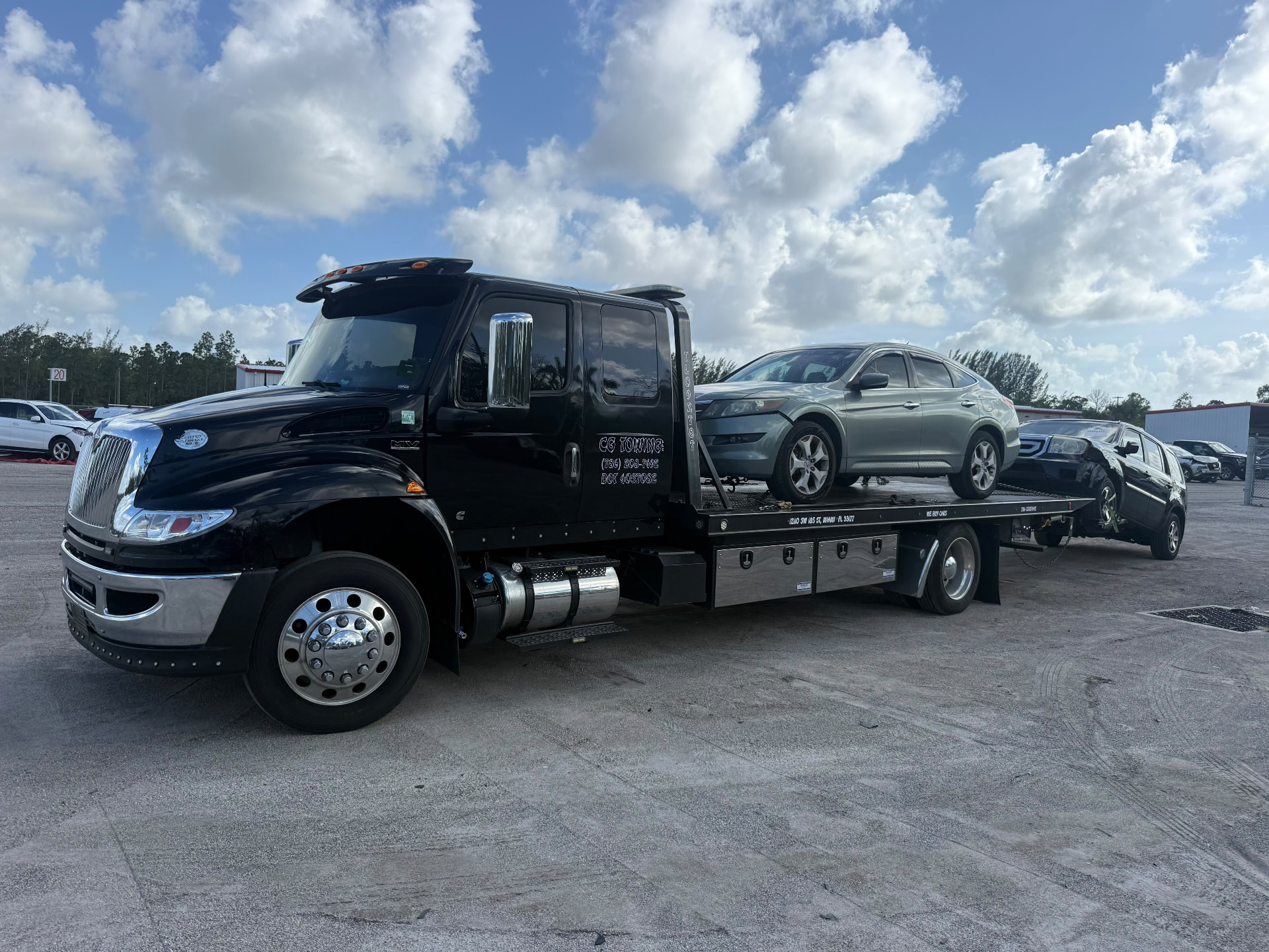 CG Towing heavy-duty flatbed truck at work