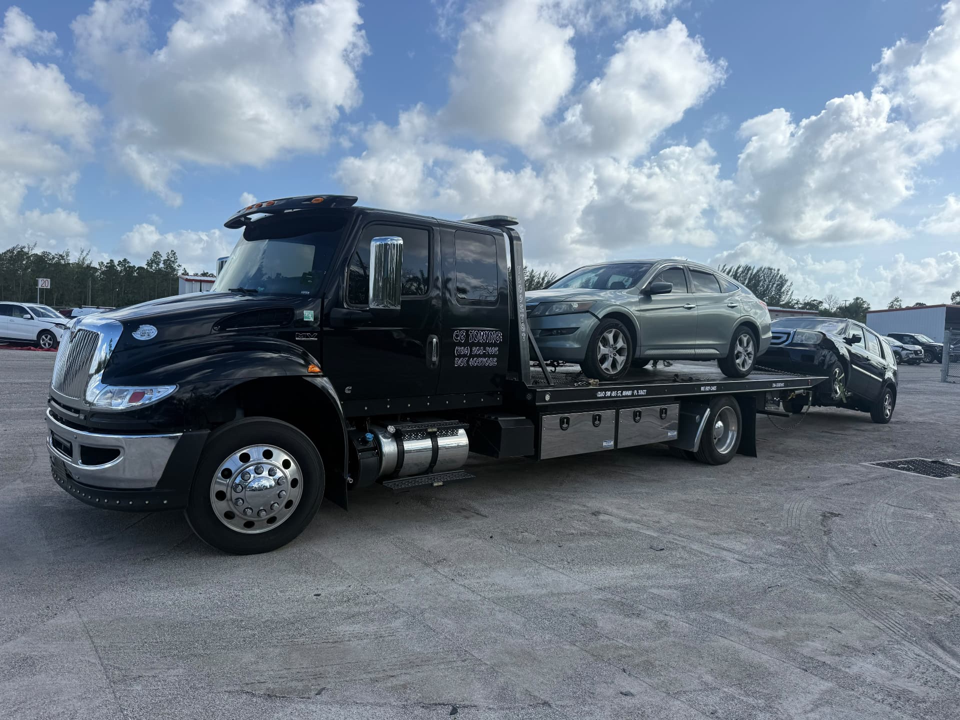 CG Towing flatbed carrying two vehicles