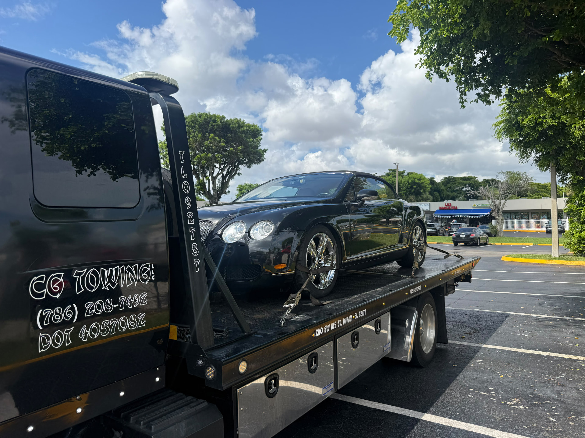 CG Towing transporting a black sedan